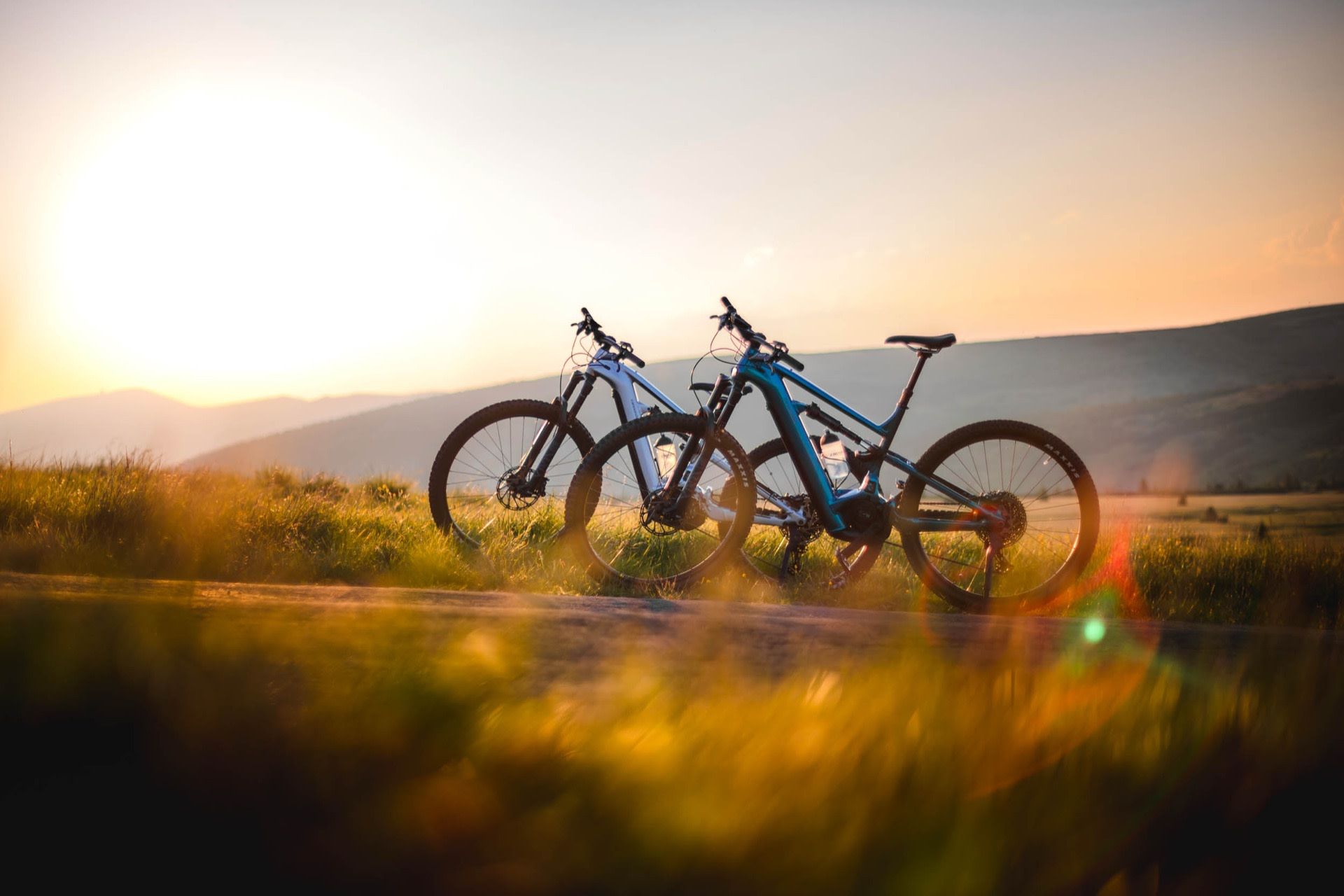 Two e-bikes on a meadow at sunset, shot for Enzian