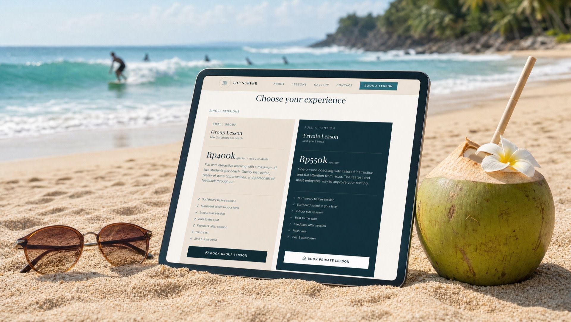 The Surfer’s new website on a tablet in the sand, a coconut beside it and surfers behind